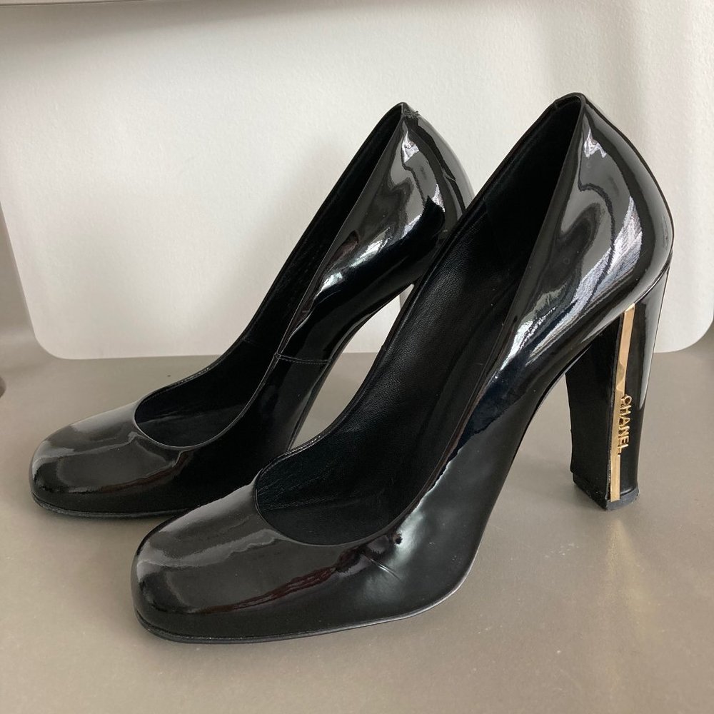 CHANEL Black Leather Pumps with Gold Accents